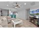 Spacious living room and breakfast bar featuring tile flooring, ceiling fan, and breakfast bar at 19624 E Umatilla Blvd, Umatilla, FL 32784