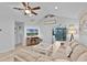 Bright living room with tile flooring, ceiling fan, and sliding door to the backyard at 19624 E Umatilla Blvd, Umatilla, FL 32784