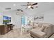 Bright living room features tile flooring, ceiling fan, vaulted ceiling, and sliding door to the backyard at 19624 E Umatilla Blvd, Umatilla, FL 32784