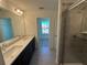 This bathroom features double sinks and a glass shower with tile surround at 1995 Iorio St, St Cloud, FL 34771