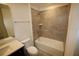 Bathroom with tiled tub, vanity and integrated sink and tile floors at 1995 Iorio St, St Cloud, FL 34771