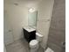 Bathroom with dark vanity, quartz counter, and a tile shower at 1995 Iorio St, St Cloud, FL 34771