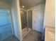 Bathroom featuring a glass-enclosed shower and tile flooring at 1995 Iorio St, St Cloud, FL 34771