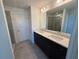 Bathroom featuring double vanity, dark cabinetry, and a glass-enclosed shower at 1995 Iorio St, St Cloud, FL 34771