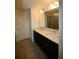 Bathroom featuring double vanity, dark cabinetry, and a glass-enclosed shower at 1995 Iorio St, St Cloud, FL 34771