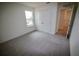 Cozy bedroom with plush gray carpet, double closet, and bright natural light at 1995 Iorio St, St Cloud, FL 34771