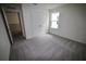 Neutral bedroom features gray carpet, a double door closet, and a window at 1995 Iorio St, St Cloud, FL 34771