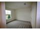 A bedroom with neutral carpet, a window, and a closet at 1995 Iorio St, St Cloud, FL 34771