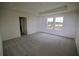 Spacious bedroom featuring a tray ceiling and a view from the windows at 1995 Iorio St, St Cloud, FL 34771