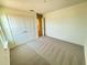 Modern bedroom featuring neutral carpet, a large closet and a window at 1995 Iorio St, St Cloud, FL 34771