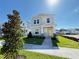 Charming two-story home with yellow door and landscaped front yard under a sunny sky at 1995 Iorio St, St Cloud, FL 34771