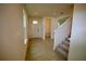 Hallway with view of front door, stairs, and half bathroom at 1995 Iorio St, St Cloud, FL 34771