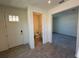 Hallway with tile flooring that flows to a guest bathroom and a bedroom at 1995 Iorio St, St Cloud, FL 34771