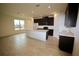 Bright kitchen and dining area with tile floors, dark cabinets, and stainless steel appliances at 1995 Iorio St, St Cloud, FL 34771