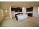Spacious kitchen with center island, dark cabinets, stainless appliances, and light countertops at 1995 Iorio St, St Cloud, FL 34771