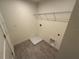 A simple laundry room with tile flooring and a wire rack at 1995 Iorio St, St Cloud, FL 34771