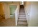 View of a carpeted staircase with white railings leading to the upper level at 1995 Iorio St, St Cloud, FL 34771