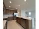 Modern kitchen featuring an island with a sink, stainless steel appliances, and tiled backsplash at 1996 Heart Lake Dr, Groveland, FL 34736