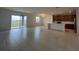 Open-concept living room and kitchen area with tile floors and sliding glass doors at 1996 Heart Lake Dr, Groveland, FL 34736