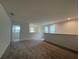 A view of the upstairs loft with carpet flooring and several windows for lots of natural lighting at 1996 Heart Lake Dr, Groveland, FL 34736