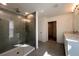 Modern bathroom featuring a glass enclosed shower, dual sinks and a walk-in closet at 2000 Heart Lake Dr, Groveland, FL 34736