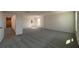 Spacious bedroom with neutral carpet and natural light coming in from two windows at 2000 Heart Lake Dr, Groveland, FL 34736