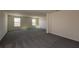 Empty and spacious bedroom with neutral carpet and natural light coming in from two windows at 2000 Heart Lake Dr, Groveland, FL 34736
