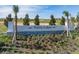 Beautiful Trinity Lakes signage with stone accents, lush flowers, and picturesque landscaping at 2000 Heart Lake Dr, Groveland, FL 34736