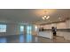 Open-concept living room and kitchen area with tiled flooring and abundant natural light at 2000 Heart Lake Dr, Groveland, FL 34736