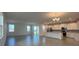 Open-concept living room and kitchen area with tiled flooring and abundant natural light at 2000 Heart Lake Dr, Groveland, FL 34736