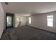 Upstairs loft area featuring carpet, neutral walls and natural light from three windows at 2000 Heart Lake Dr, Groveland, FL 34736