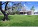 Expansive backyard showcasing lush greenery and a covered patio, ideal for outdoor entertaining at 2102 Nedra Ave, Deltona, FL 32725