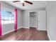 Bedroom with ceiling fan and closet with pink curtains and ample natural light at 2102 Nedra Ave, Deltona, FL 32725