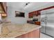 Modern kitchen features granite countertops, stainless steel appliances, and wood cabinets at 2102 Nedra Ave, Deltona, FL 32725