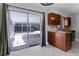 Kitchen area featuring wood cabinets, granite countertops, and sliding glass doors to the screened patio at 2102 Nedra Ave, Deltona, FL 32725