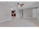 Open-concept living room with tile flooring, ceiling fan, and a view into the kitchen area at 2102 Nedra Ave, Deltona, FL 32725