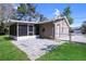 Back of the house with screened-in patio and fenced in backyard at 2102 Nedra Ave, Deltona, FL 32725