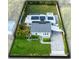Overhead view of the home showcasing the manicured lawn, solar panels, and paved driveway at 211 E Muriel St, Orlando, FL 32806