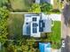 Aerial view of the property showcasing the solar panels, well-maintained lawn, and convenient location at 211 E Muriel St, Orlando, FL 32806