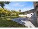 Spacious backyard featuring a covered patio and privacy fence, perfect for outdoor entertaining at 211 E Muriel St, Orlando, FL 32806