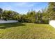 Expansive backyard with lush grass and a white privacy fence providing ample space for outdoor activities at 211 E Muriel St, Orlando, FL 32806