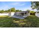 View of the backyard featuring a patio, shed, and landscaping at 211 E Muriel St, Orlando, FL 32806