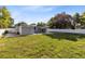 Large, well-maintained backyard with mature trees and full privacy fence at 211 E Muriel St, Orlando, FL 32806