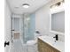 Bathroom featuring a glass shower enclosure and modern vanity with stylish fixtures at 211 E Muriel St, Orlando, FL 32806