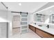 Modern bathroom featuring a double vanity, sleek fixtures, and a glass-enclosed shower at 211 E Muriel St, Orlando, FL 32806