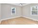 Bedroom featuring natural light from two windows and light wood flooring at 211 E Muriel St, Orlando, FL 32806