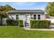 Charming single-story home with gray siding, manicured hedges, and a well-maintained lawn at 211 E Muriel St, Orlando, FL 32806