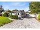Charming home showcasing gray siding, manicured hedges, and a spacious paved driveway at 211 E Muriel St, Orlando, FL 32806