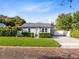 Charming home with beautifully landscaped front yard, lush lawn, and a paved driveway at 211 E Muriel St, Orlando, FL 32806