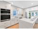 Modern kitchen featuring white cabinets, stainless steel appliances, and a center island at 211 E Muriel St, Orlando, FL 32806